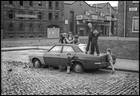 kids playing on a car